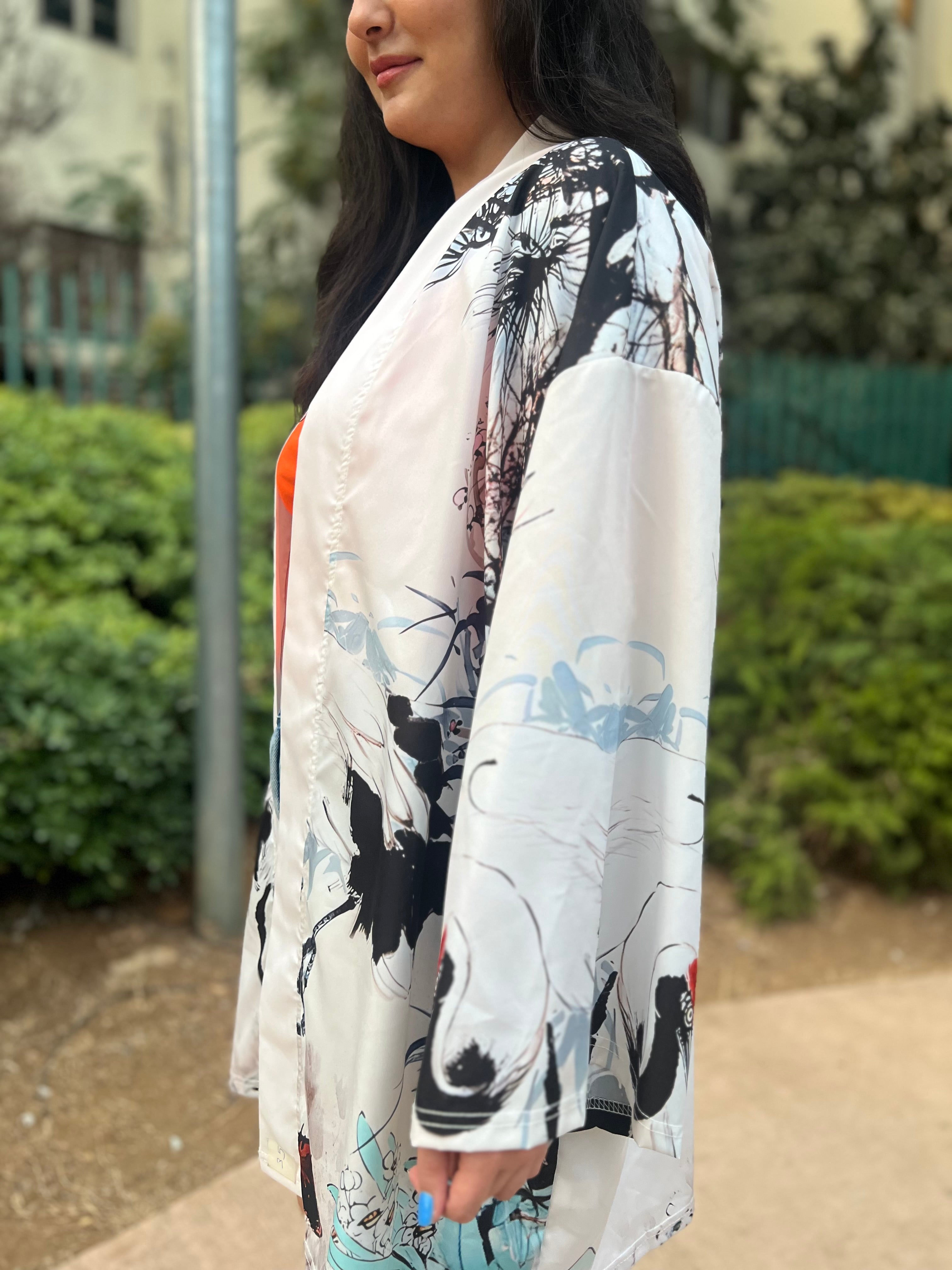 Woman wearing a floral kimono-style garment with a blurred outdoor background