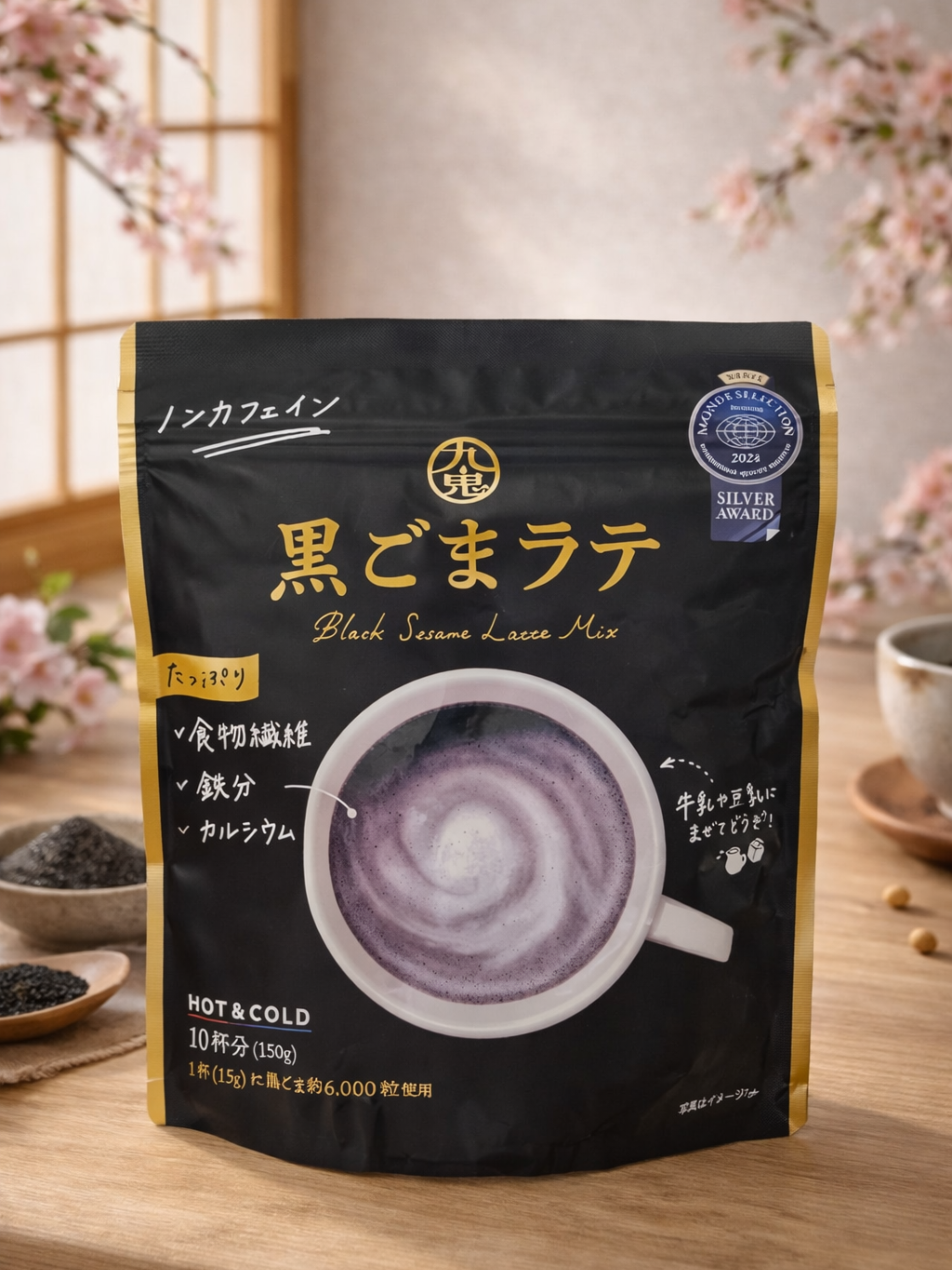 Black sesame latte mix package with a cup of latte on a wooden surface with cherry blossoms in the background.