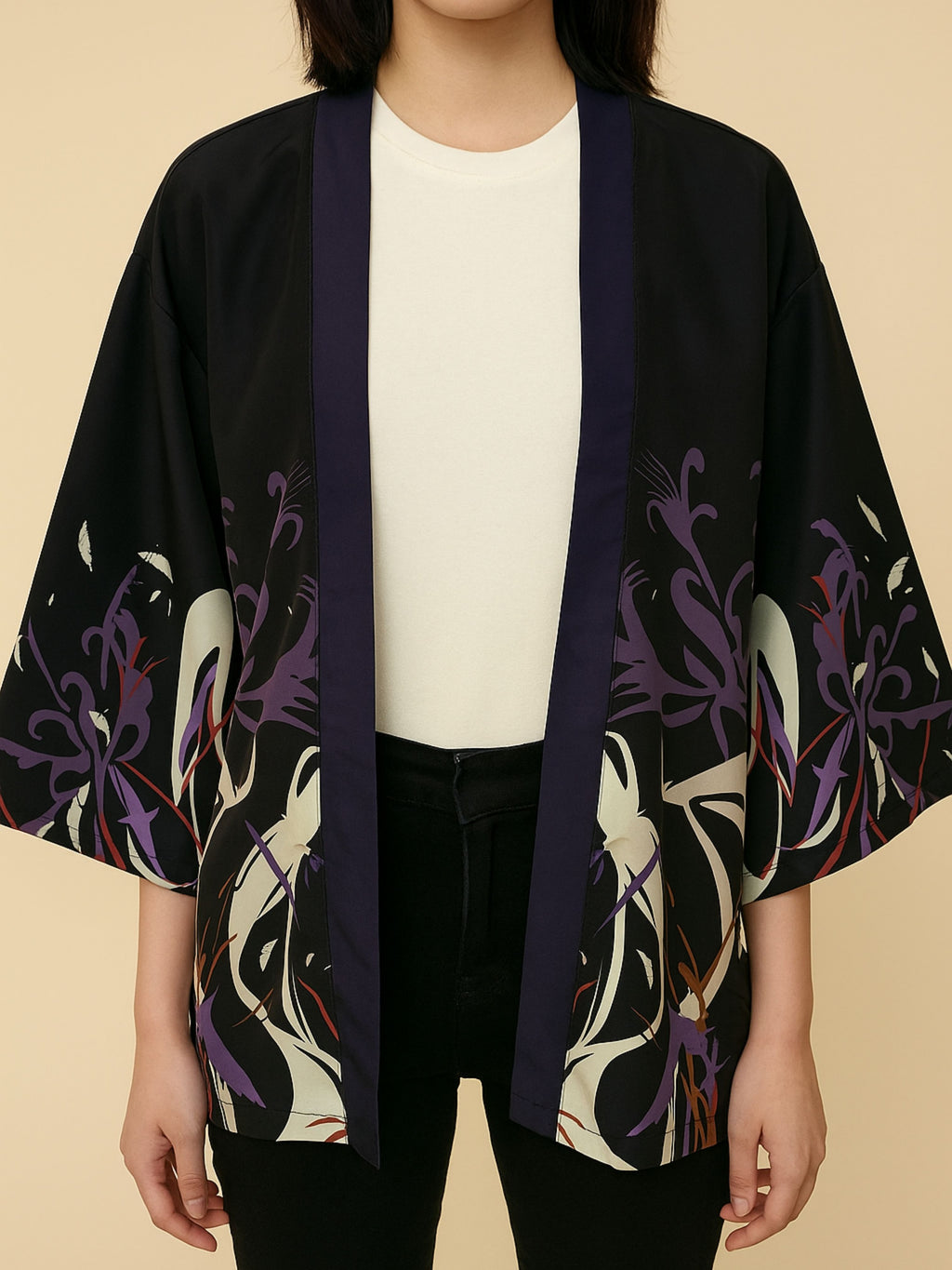 Person wearing a black kimono with abstract floral patterns on a beige background