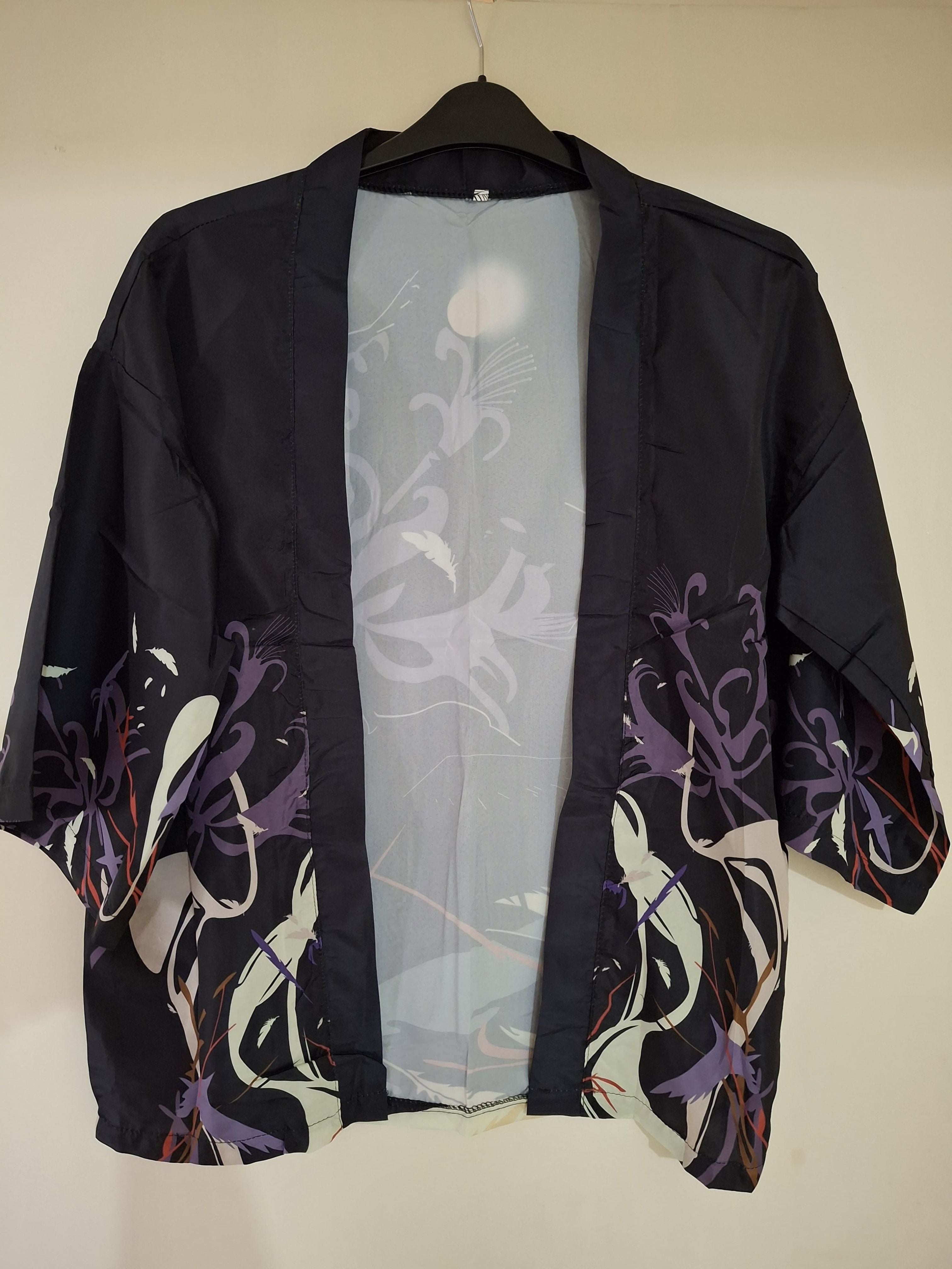Black kimono with floral patterns on a beige background