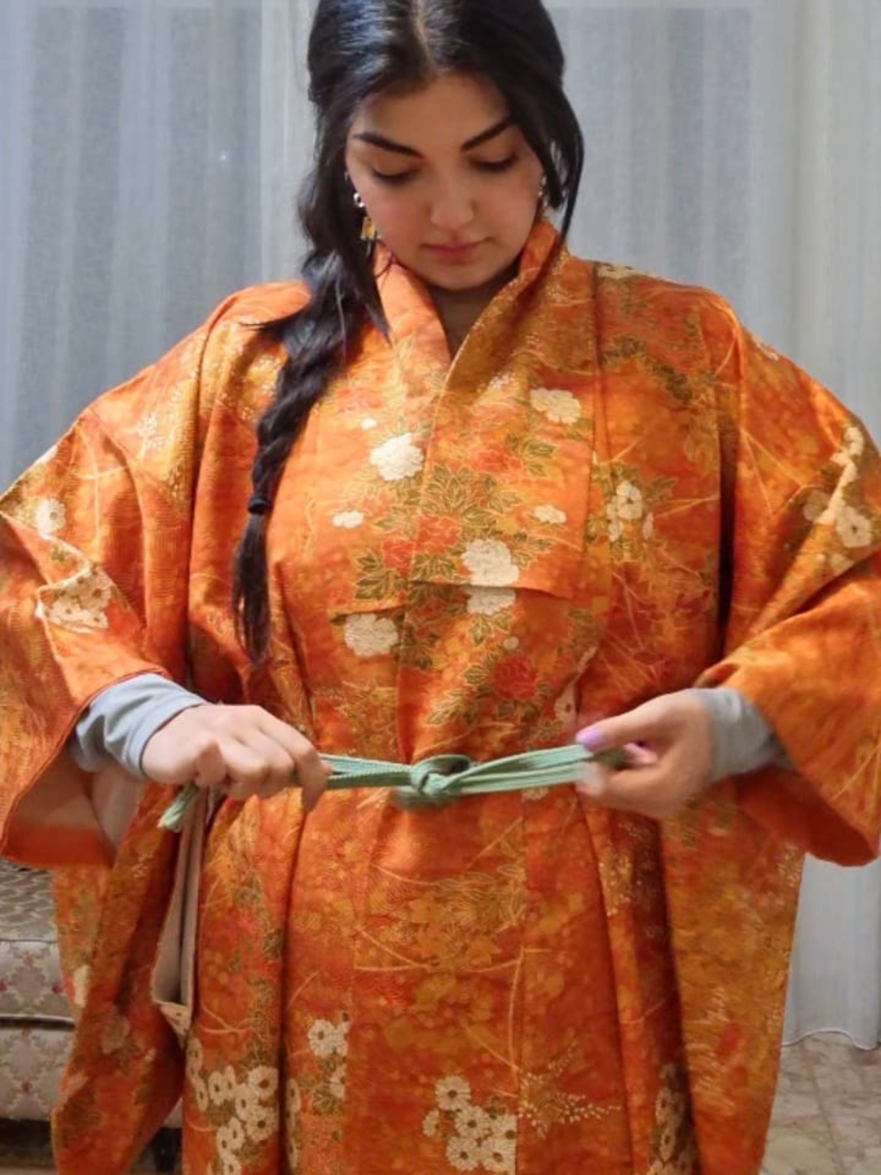 Girl wearing authentic Japanese kimono orange with florals