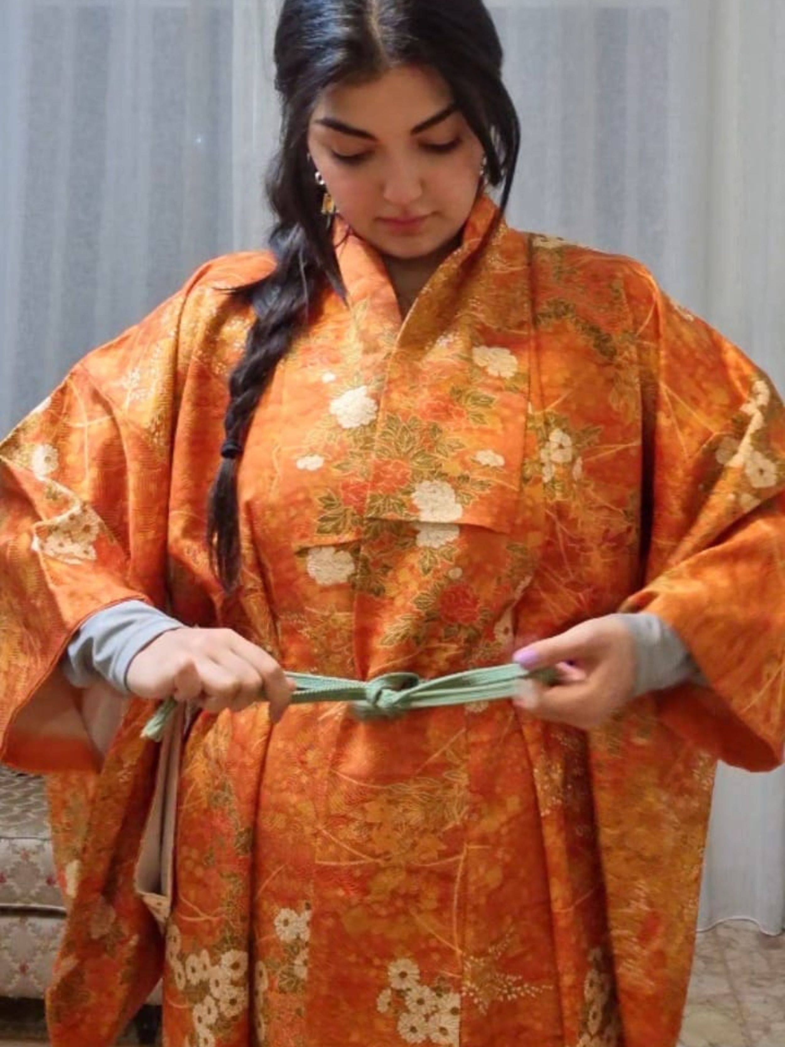 Girl wearing authentic Japanese kimono orange with florals